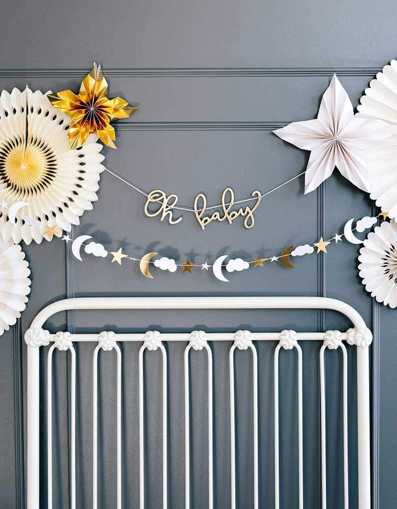 Baby nursery decoration ideas featuring my mind's eye oh baby banner set and baby pink fans on the wall