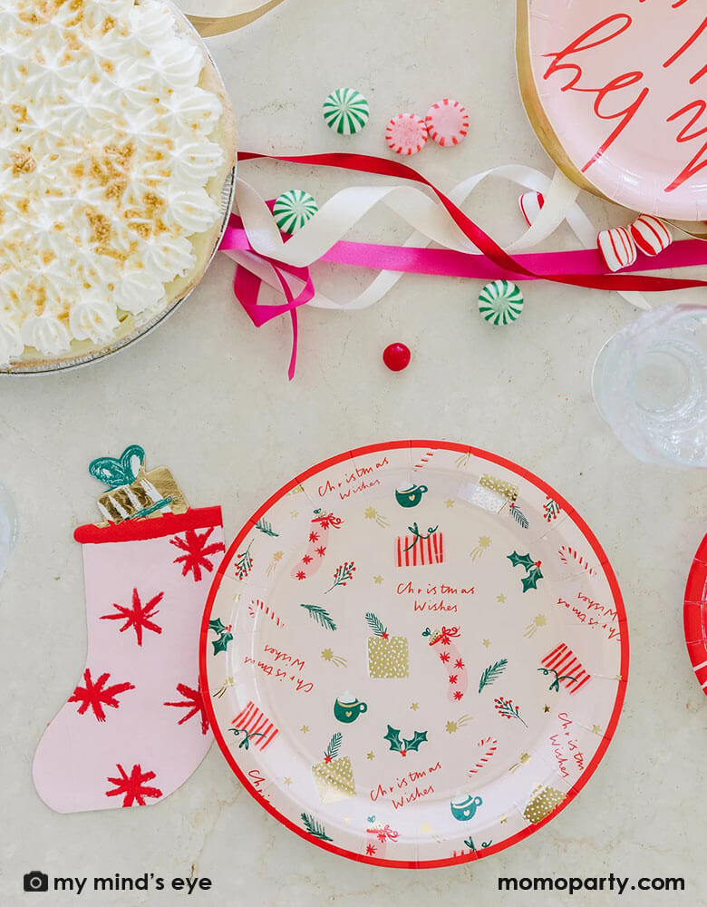 Pretty pink Christmas stocking napkins from My Minds Eye to make wishes come true for all!Cute die cut stocking shape is soft and whimsical and a beautiful table piece. The napkins are a modern pink color with red starbursts and even a stuffed toy with gold foil accents and a green bow! There are 18 napkins sized 4.5 x 6.5 inches. Pair beautifully with Christmas wishes and holiday plates at momoparty.com. Add peppermint twists, kisses, candycane, hot cocoas and marshmallows for a cozy fun holiday table.