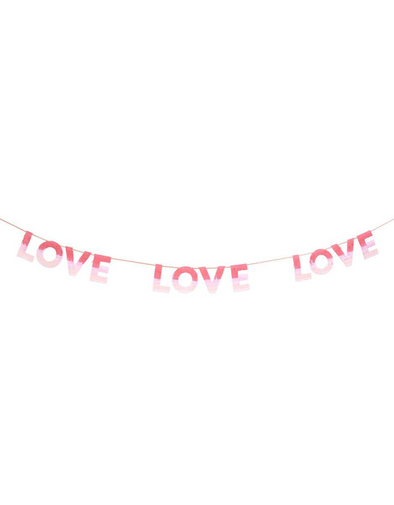 Meri Meri Ombre Love Garland with fringed tissue paper, with each letter having colors in red, peach and pink to achieve an ombre effect. Perfect for a Valentine's Day or Galentine's Day celebration