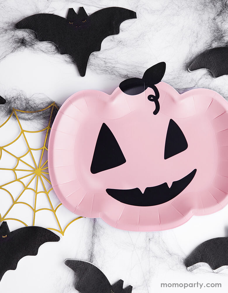 A not-so-spooky Halloween table featuring Party Deco Pink Pumpkin Plates surrounded by Bat napkins and gold spider web decorations