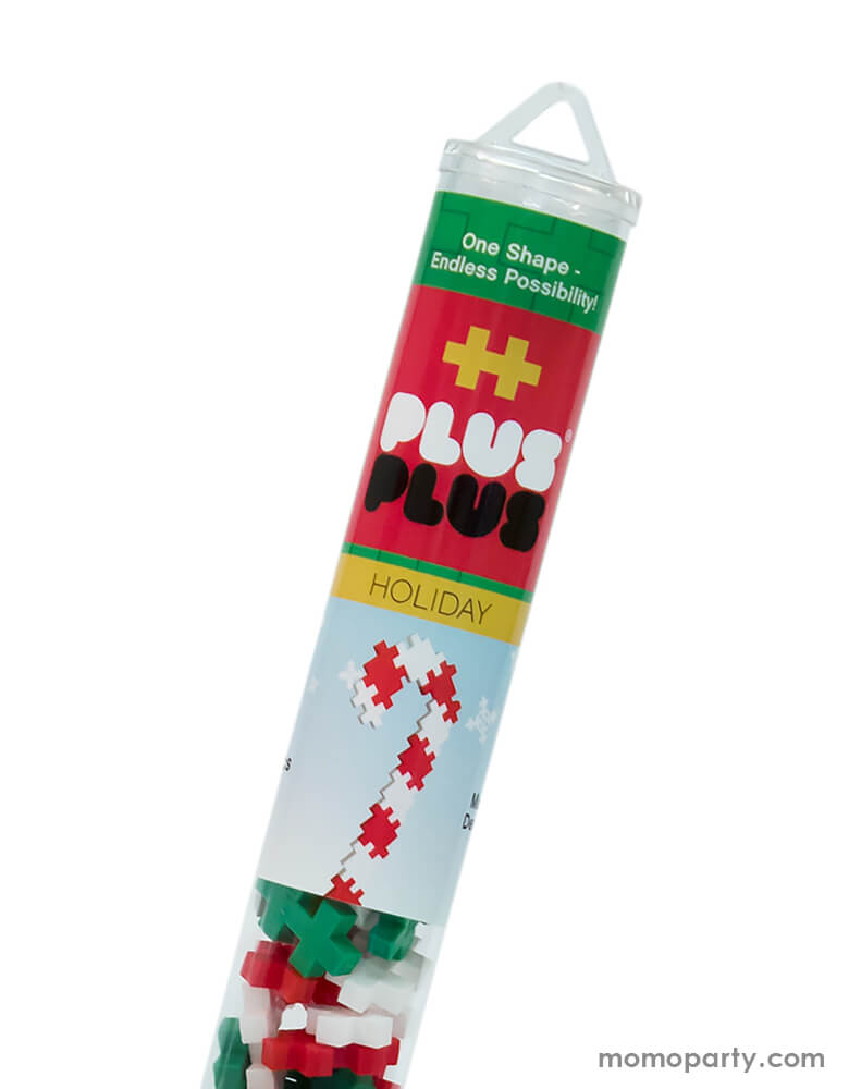Close up package of Plus-Plus Holiday Tube. The 70 piece Holiday tube with white green and red colors, makes a great stocking stuffer this Holiday season, A perfect STEM toy to develop fine motor skills, focus and patience - as well as design, imagination and creativity!