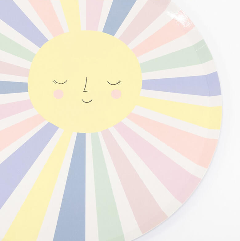 detail look of meri Meri Rainbow Sun Dinner Plates. They feature a smiling sun with lots of colorful rays.