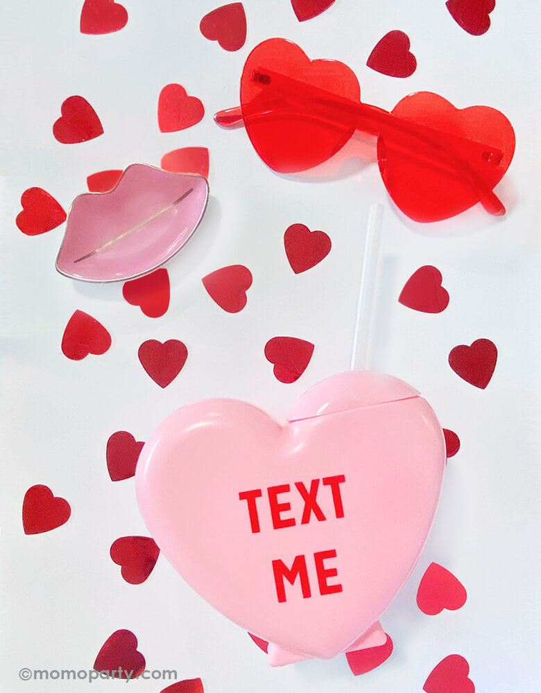 Valentine's or Galentine's Day celebration decorated with Party Deco - metallic Red Heart shaped Confetti,  sweet-talker-conversation-heart-tumbler in pink with "text me" text print in red, and a heart shaped sunglass. 