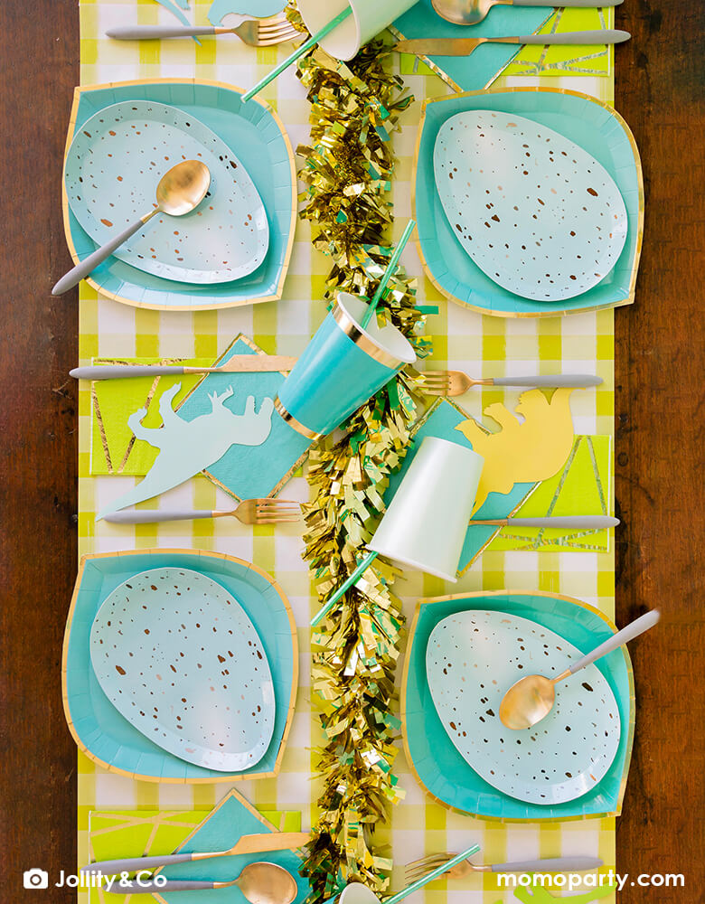 Dinosaur themed party table set up with Rockin' Robin Dinner Plates layered with Posh Chill Out Plates, some dinosaur shaped paper cuts, on a yellow gingham table runner