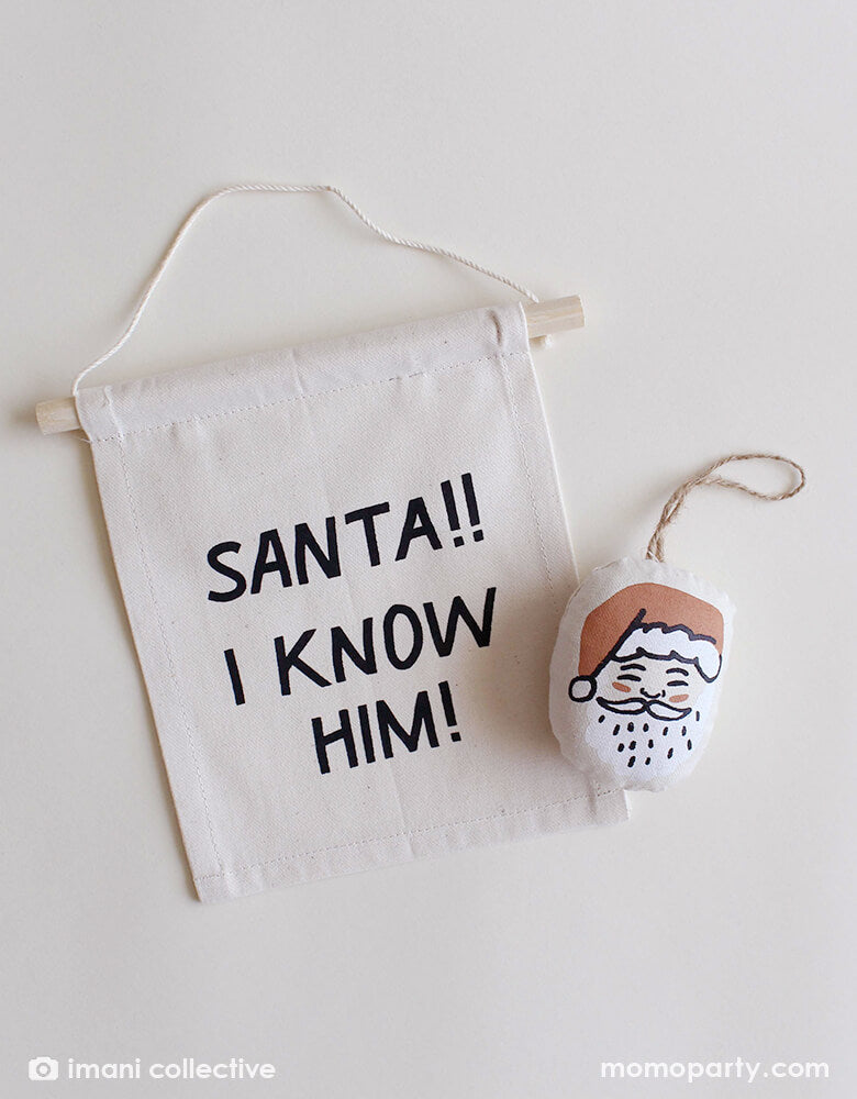Imani Collective - Santa plush Ornament and "Santa!! I know him!" Christmas hang sign. These modern Plush ornament and hang sign made with Natural canvas and printing was sewn and screen printed by hand on natural canvas by local artisans in Kenya. This modern holiday decoration is perfect for this Holiday season, christmas tree decoration, holiday small gift. Sold by Momo party store provided modern party supplies, boutique party supplies, chic holiday party supplies and high end party supplies