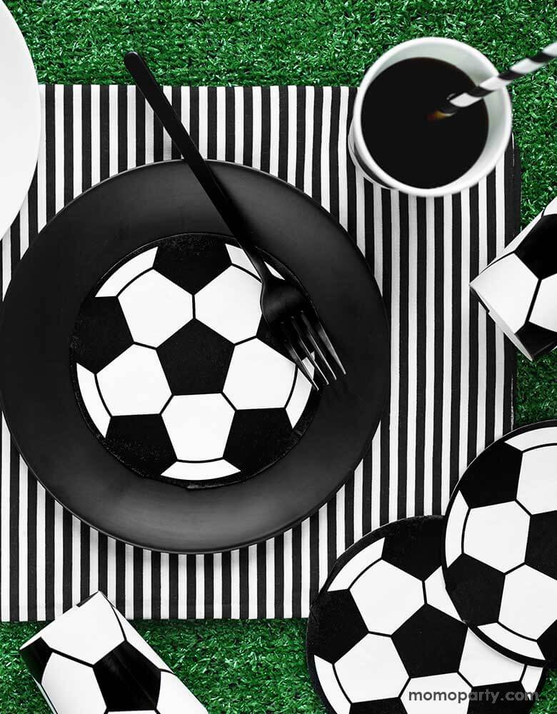 Party deco's soccer ball napkins and plates on a Green Party table for a soccer themed birthday party