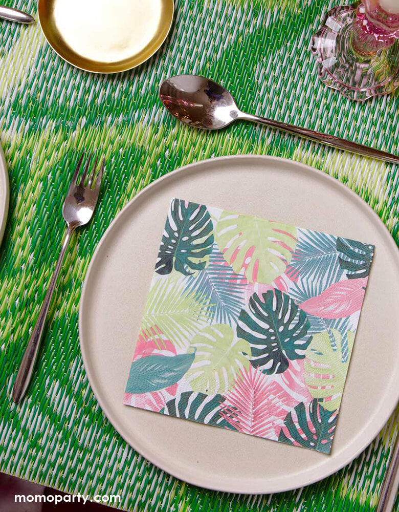 Tropical themed party table look with Fiesta Pink Palm Napkins on top of pink ceramic round plates, with green bamboo table mat. Perfect for a tropical party, summer birthday, picnic, BBQ or garden party!