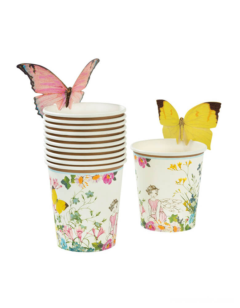 Truly Fairy Paper Cups with Butterfly Detail by Talking Tables . These cups Featuring a beautiful floral fairy setting design, these cups come with sweet butterflies to attach to the top of your cups, adding that extra touch of magic. A brilliant addition to your table if you’re in search of fairy styled party ideas.  These cups look great with our Truly Fairy paper plates and napkins, to create a magical fairytale setting. Each pack contains 12 paper cups with butterflies in 2 different designs.