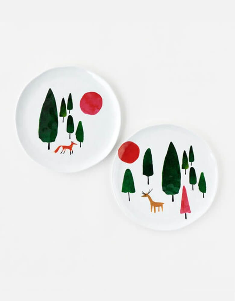 One hundred and eighty 9" winter forest melamine plates feature green trees and festive red and pink suns from the Winter Forest collection. One has a red fox, and the other a tawny deer. The unique, handmade shape looks and feels like ceramic.