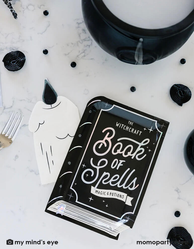 Halloween witch theme party table featuring My mind's eye witching hours book of spells shaped plates, Featuring chilling holographic foil accents, these spellbook shaped plates are a perfect addition to any Halloween party and are sure to bewitch all of your favorite ghosts and ghouls!