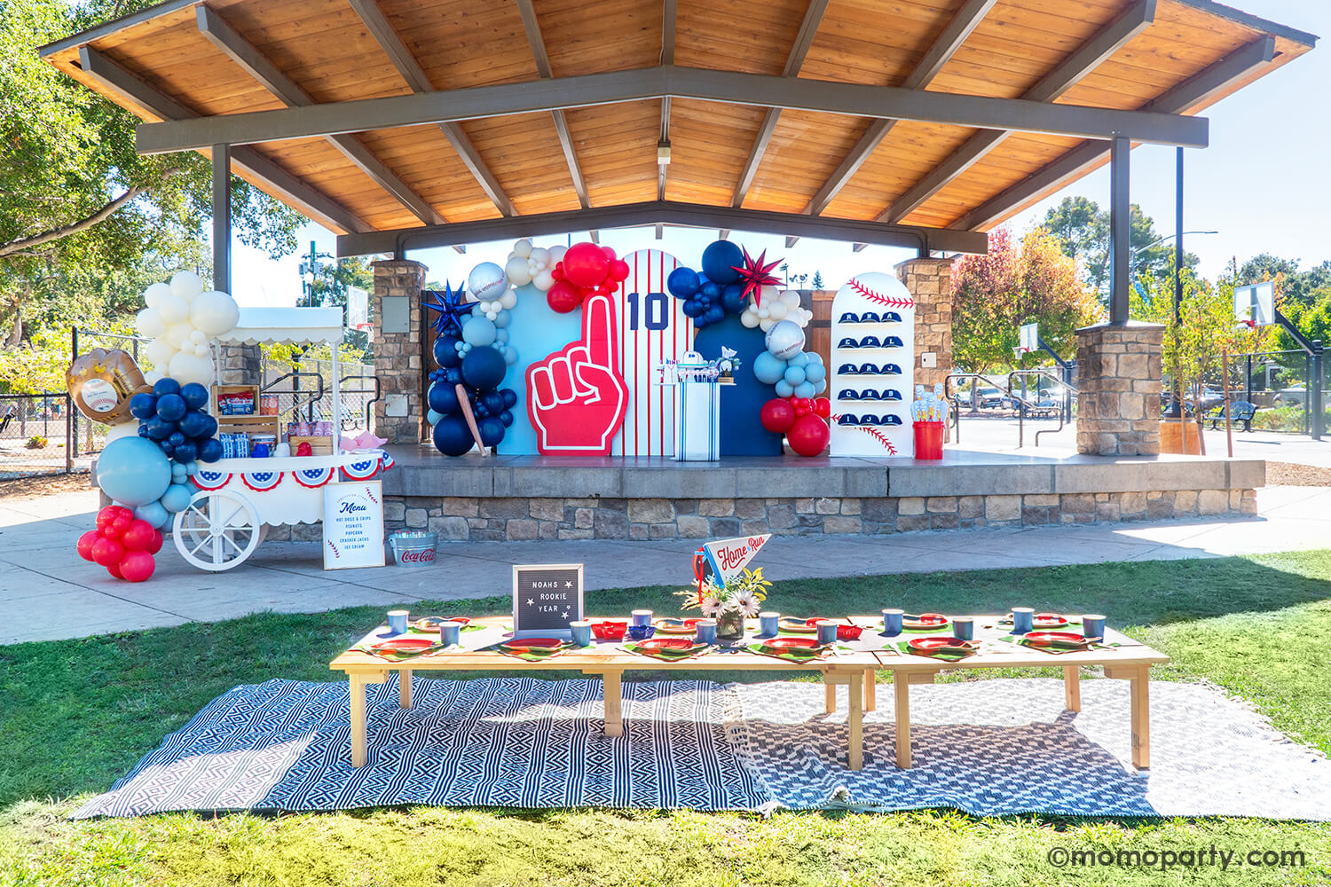 A festive and modern set up for kid's baseball themed birthday party by Momo Party