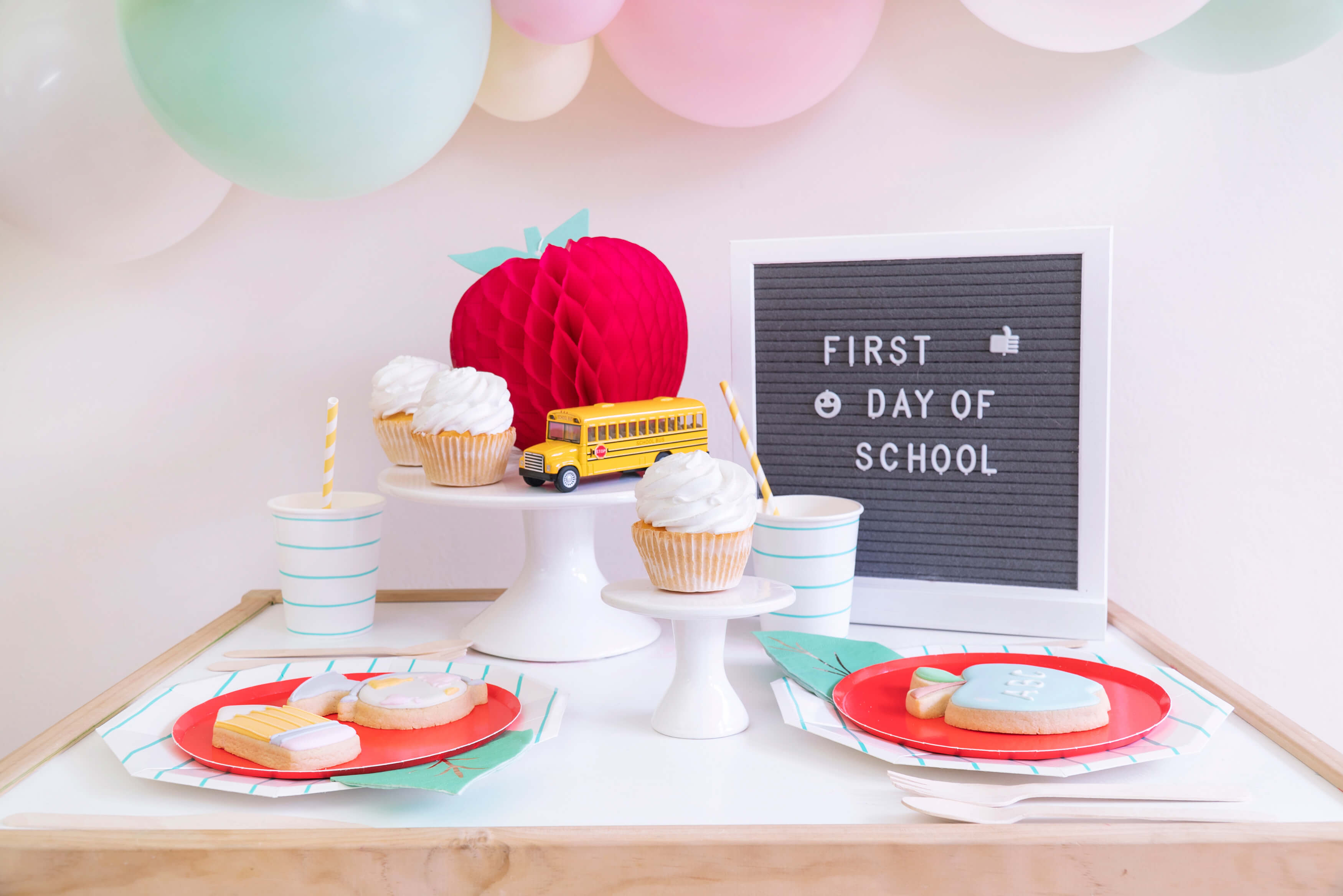 Momo party_Back to school party table set up idea with letter board, balloon garland, Apple honeycomb decoration, School bus toy, Cupcakes, Stripe paper plates, cups, Oh happy day cherry plate and cookies
