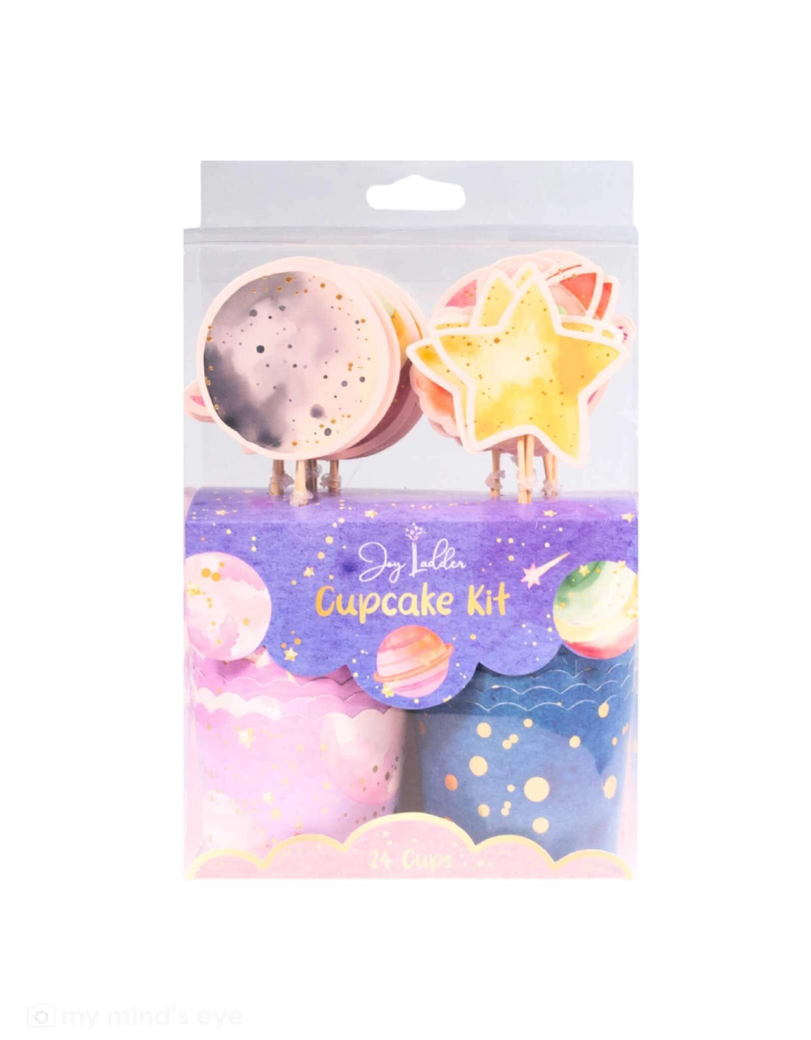 Packaged Momo Party's Astronaut Girl Space Cupcake kit in pastel pink and purple colors. The toppers have paper pennants of space themed elements including moons, planets and stars. There are two colors/designs of the wrappers. A cupcake kit that's perfect for a girl's space birthday party. 