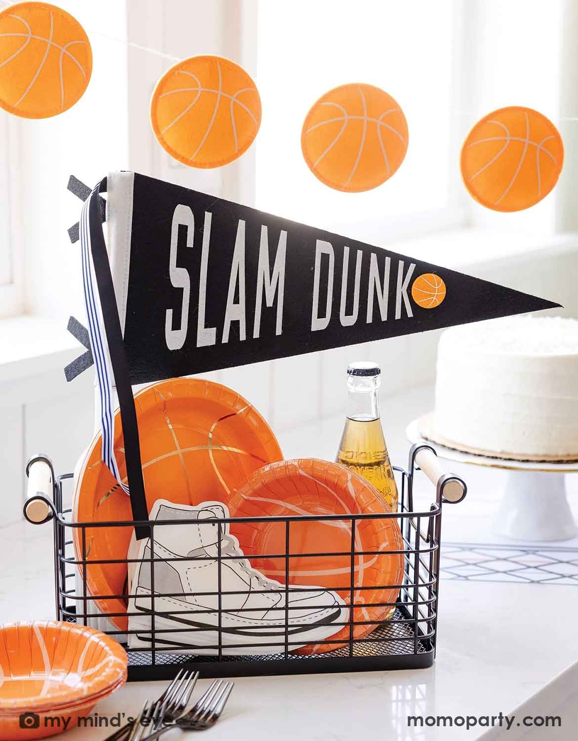 A festive basketball-themed party featuring Momo Party's basketball themed tablewares and decorations including the 'SLAM DUNK' party banner, basketball shaped plates and bowls, sneaker shaped napkins and a cake next to it - a perfect inspiration for kid's basketball themed birthday parties, an NBA viewing party, or a team celebration.