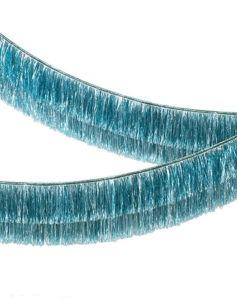Momo Party's 6ft Blue Tinsel Fringe Garland by Meri Meri. Includes 2 layer tinsel fringe and silver ribbon ties, it's perfect for any celebration, or you can use it to decorate any room where you want style and shine.