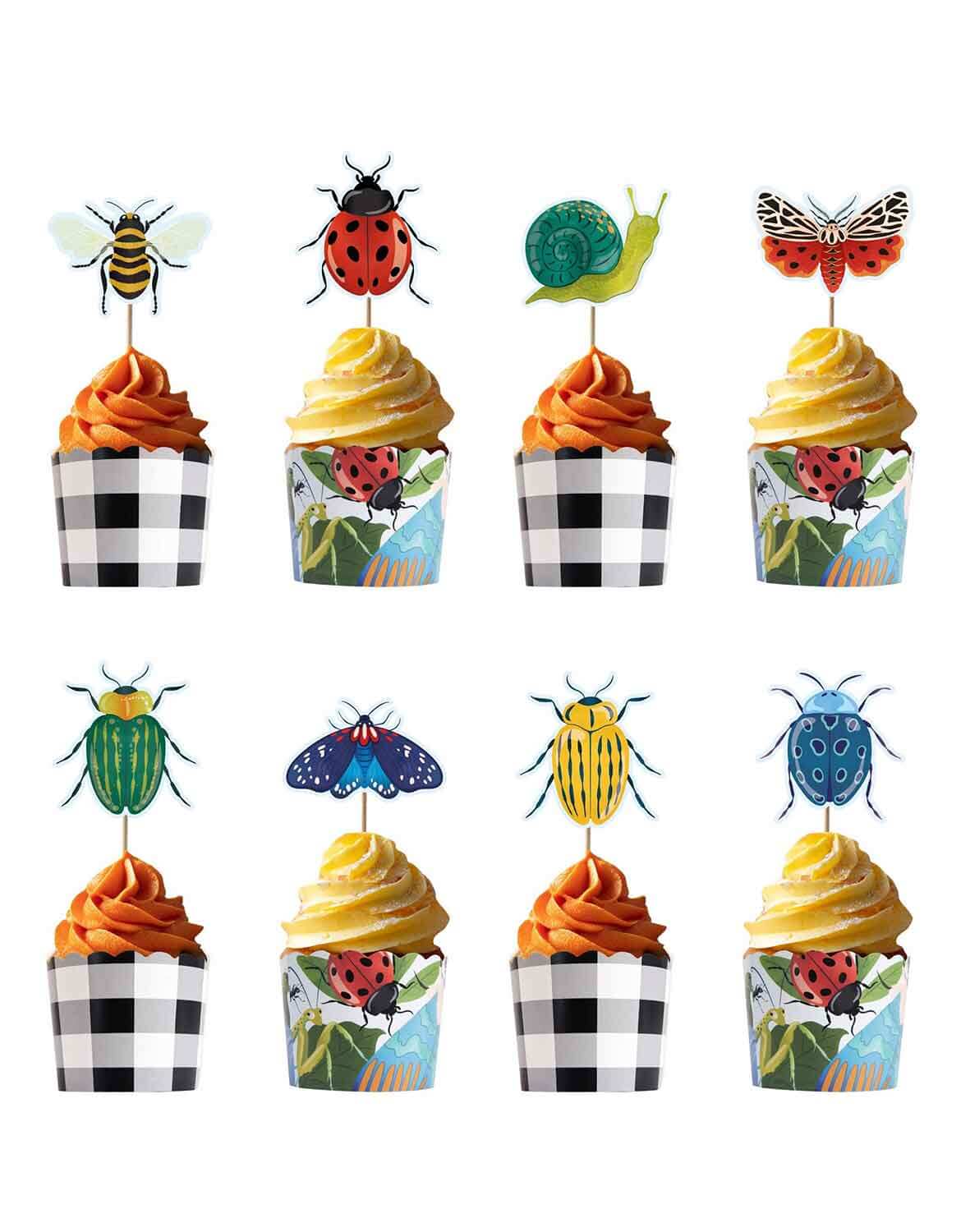 A set of bug themed cupcake toppers and wrappers with insect designs from Momo Party on orange and yellow cupcakes on a white background.