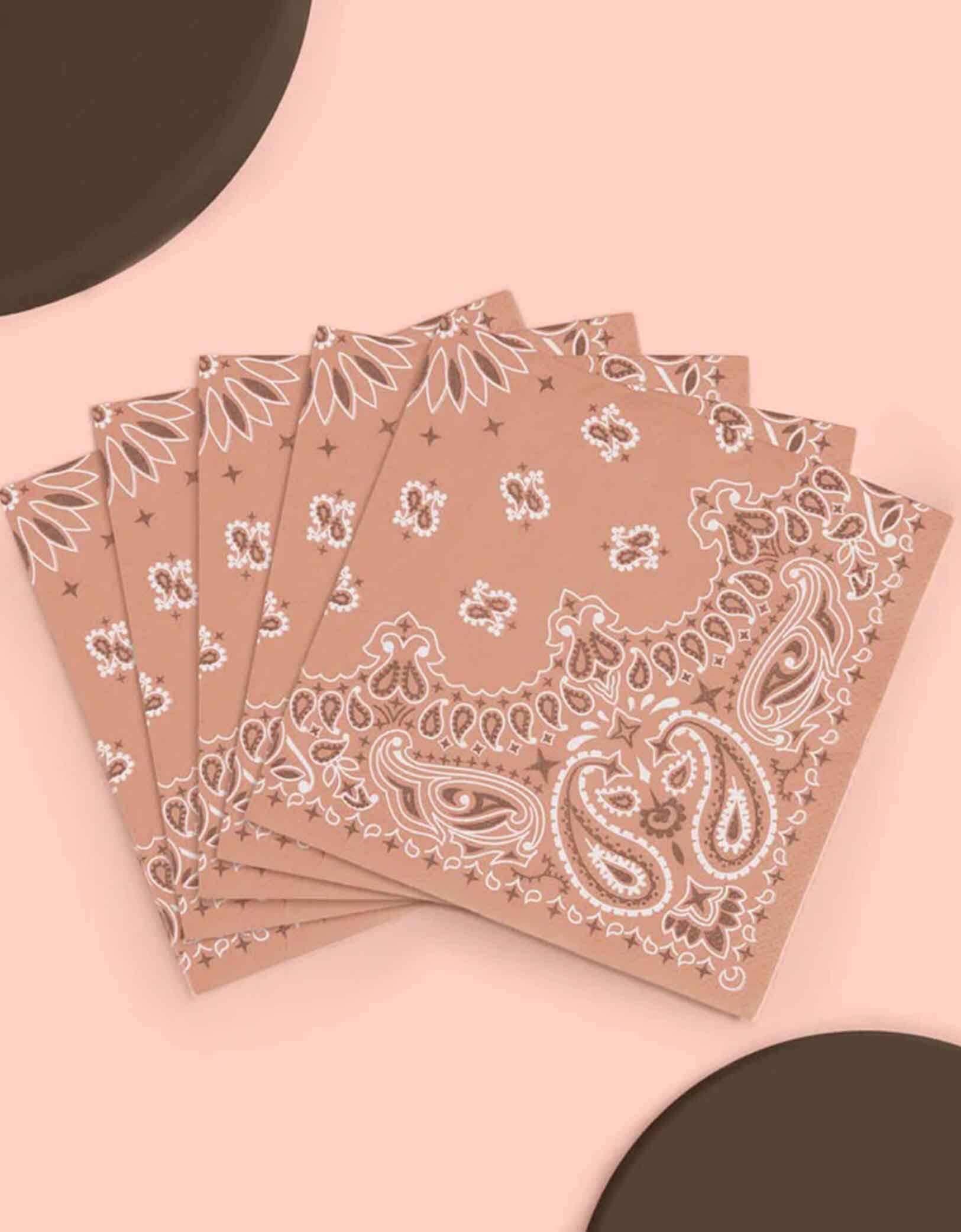 A set of 5" x 5" Western cowboy rodeo themed small napkins with bandana design from Momo Party on a beige background.