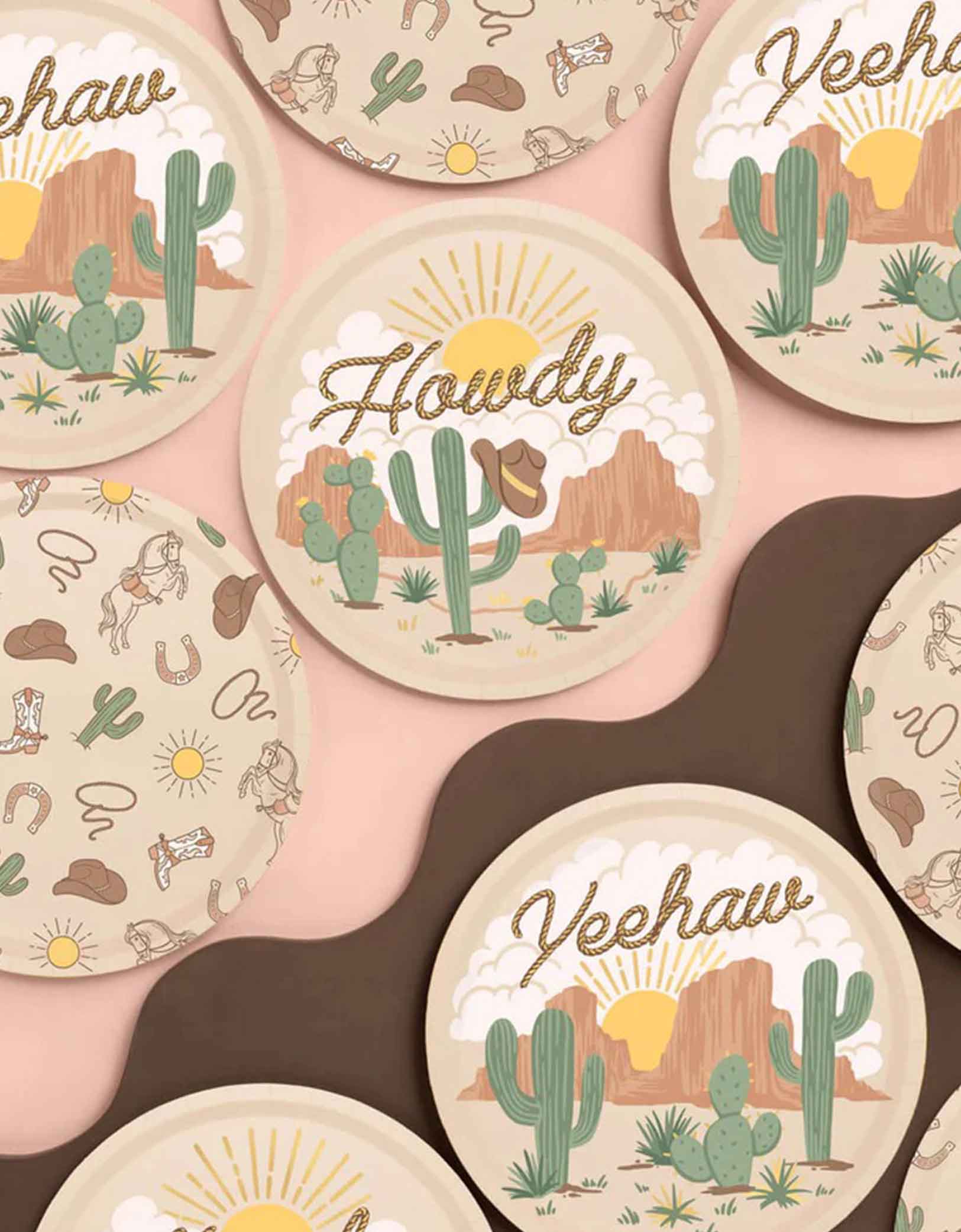 A set of 9" Momo Party's Western themed party plates with cowboy and desert-themed illustrations and text on a pink background.