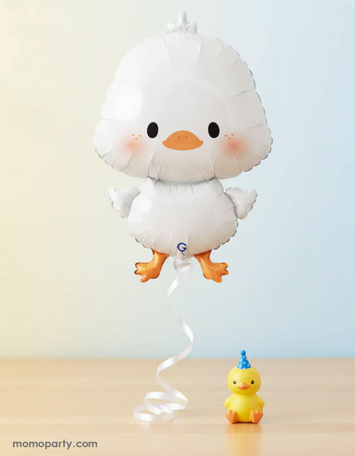 Momo Party's 25" White duckling-shaped balloon on a ribbon with a small yellow rubber duck on a light background.