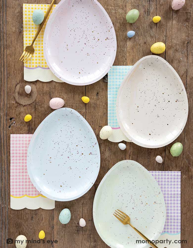 An Easter tableset feature Momo Party's 7" x 9" Easter egg shaped plates in four different pastel colors of pink, ivory, blue and green, each pairs with pastel gingham checkered guest napkins in 4 different colors of yellow, blue, yellow and purple with scallop edges. With mini Easter egg candies scattered around the table, making this an elegant yet stylish tablescape inspo this Easter.