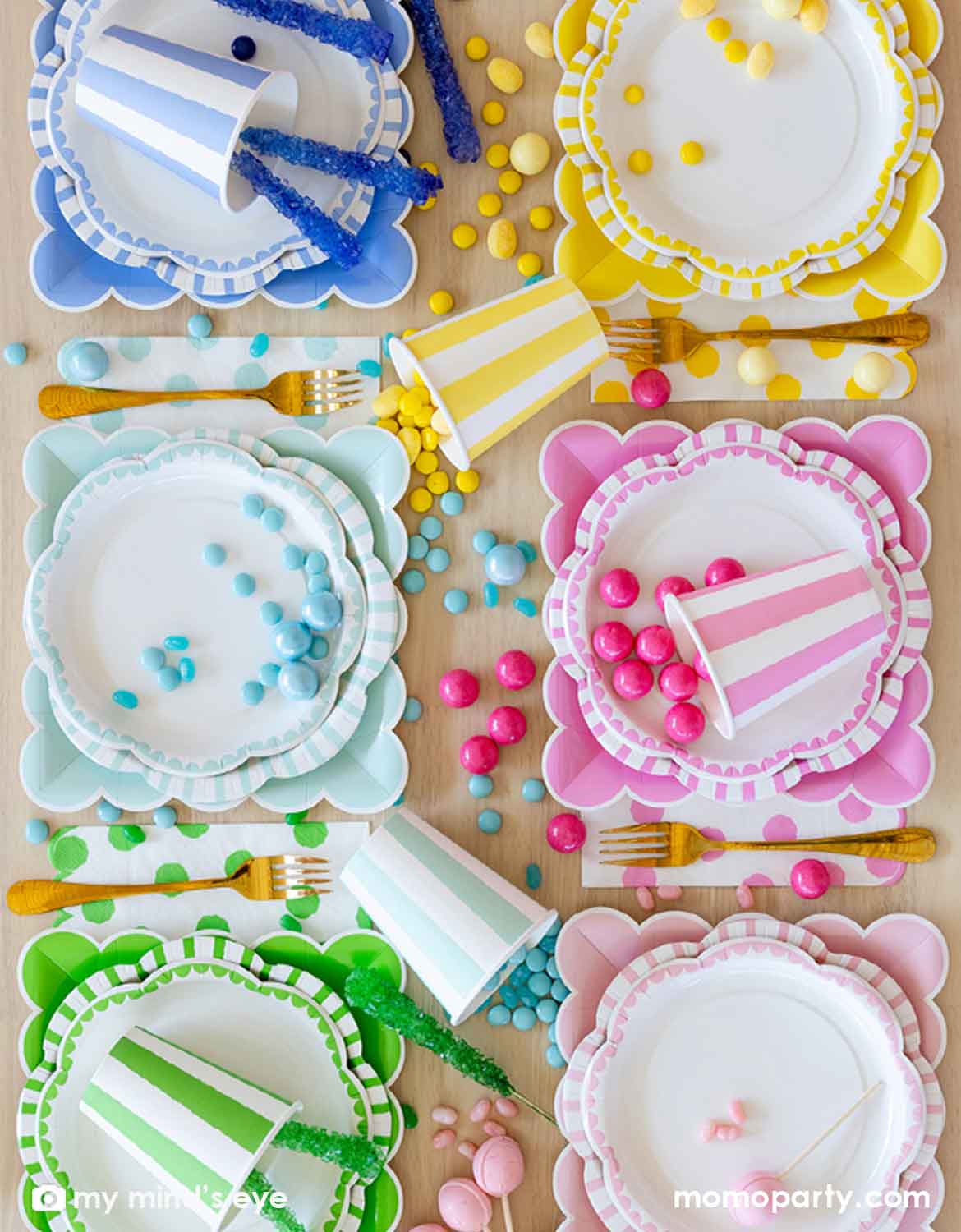 An overhead shot of a place setting featuring Momo Party's colorful paper plates, cups and napkins in blue, yellow, pink, mint, green and rose colors with color-coordinated decorative elements and treats on a wooden table.