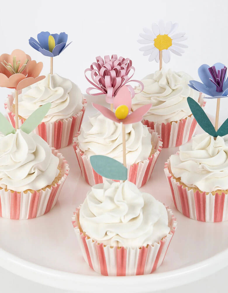 Some cupcakes decorated with Momo Party's flower garden cupcake kit which features beautiful hand crafted flowers toppers and striped cupcake cases, this gorgeous cupcake kit is a perfect addition to your spring inspired celebration or garden, floral themed birthday party.