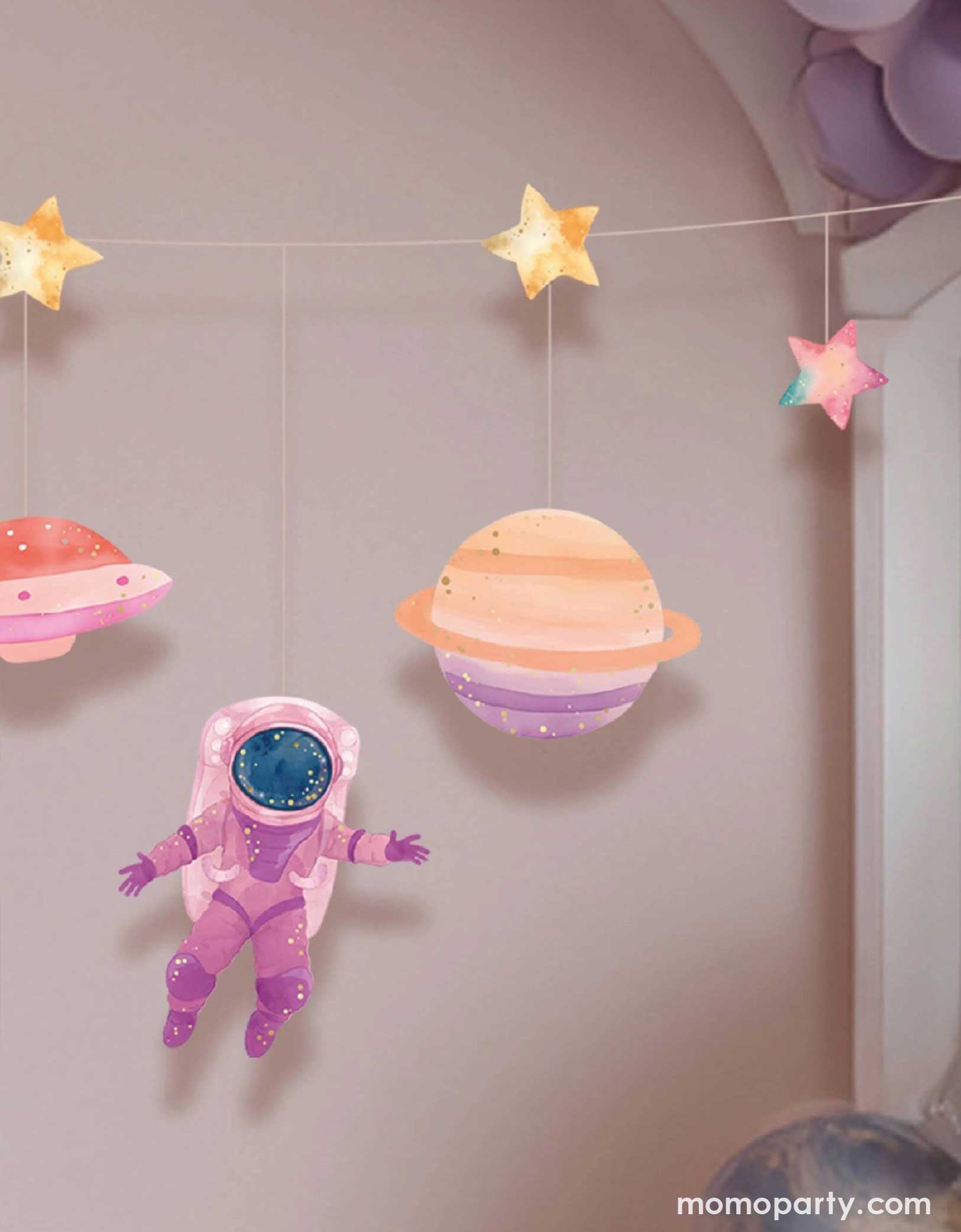 A girl's room decorated with Momo Party's astronaut girl space garland set strung with space-themed paper pennants including planets, stars, and a pink astronaut.