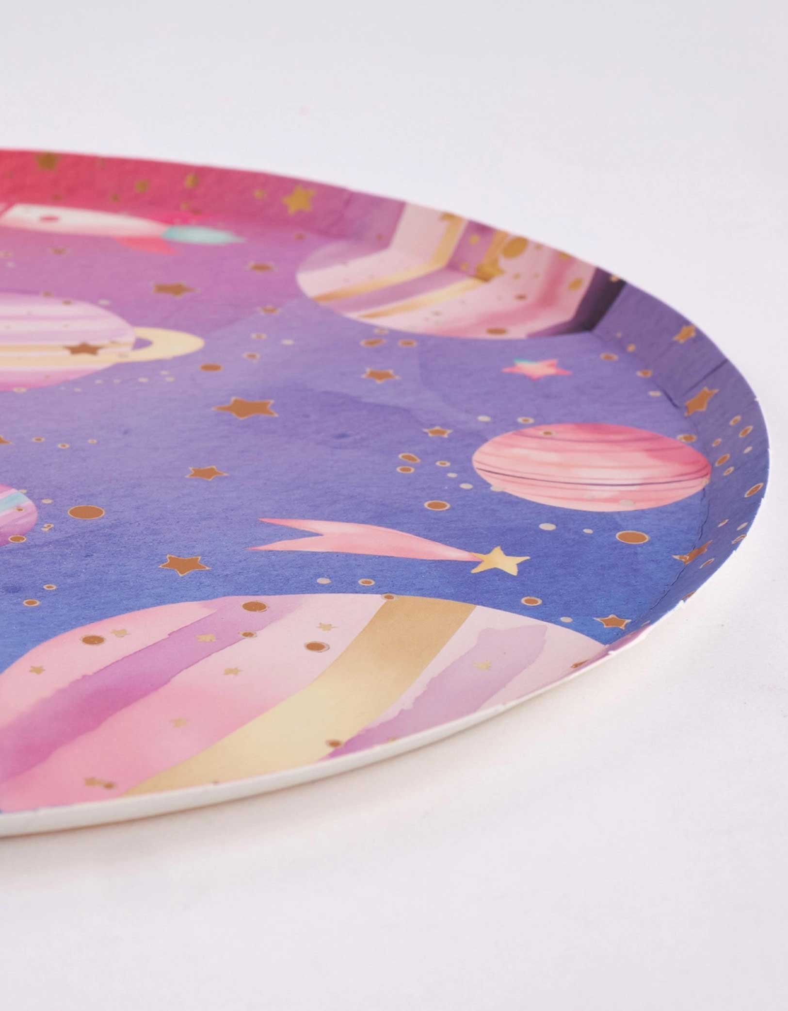 A profile shot of Momo Party's 10" round lilac and pink ombre plate with space-themed design featuring planets and stars on a white background.