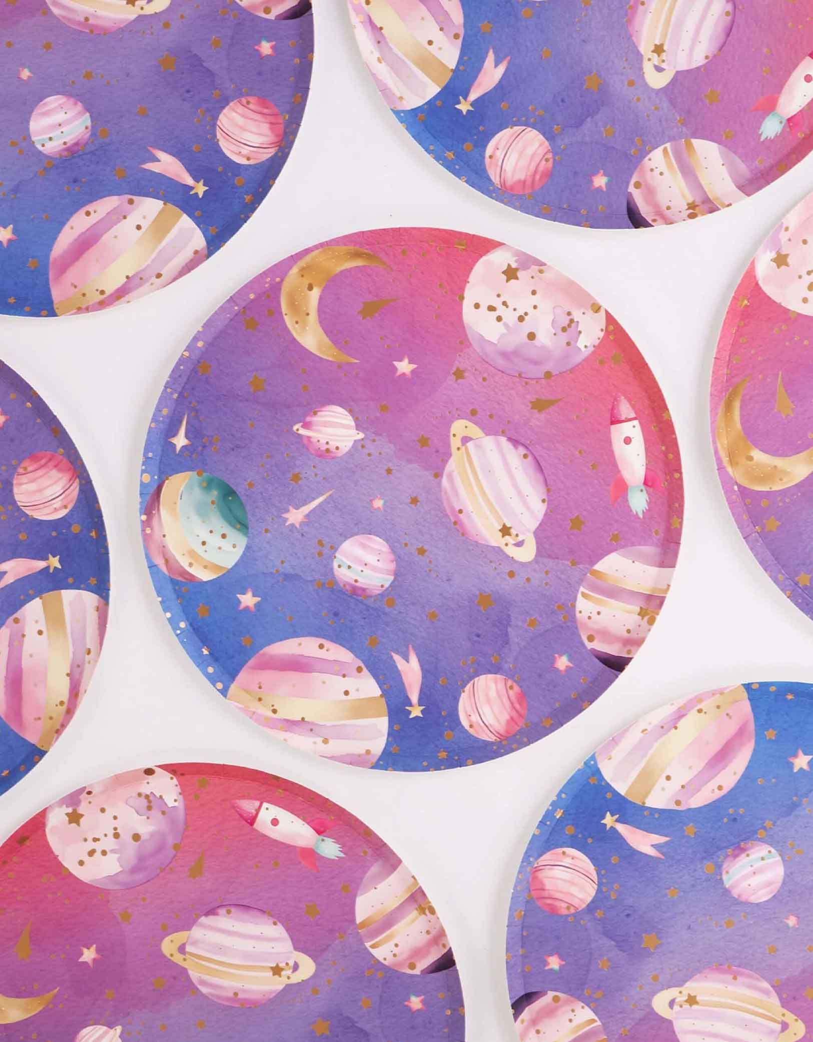 Multiple Momo Party's 10" round lilac and pink ombre plates with space-themed design featuring planets and stars on a white background.