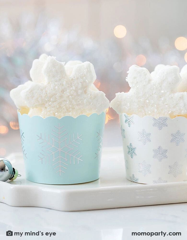 A whimsical white christmas table featuring Momo Party's Holographic Snowflakes Food Cups by My Mind'e Eye comes in a set of 50. These baking cups are perfect for baking cupcakes right in the oven. But don't limit yourself, there are so many great uses for them: add candy and wrap in cellophane for a holiday neighbor gift or party favor, cut up veggies and add dip for the perfect hors d'oeuvres at a party, bake mini quiche, or fill with fun snacks! There are so many options with these adorable cups!  