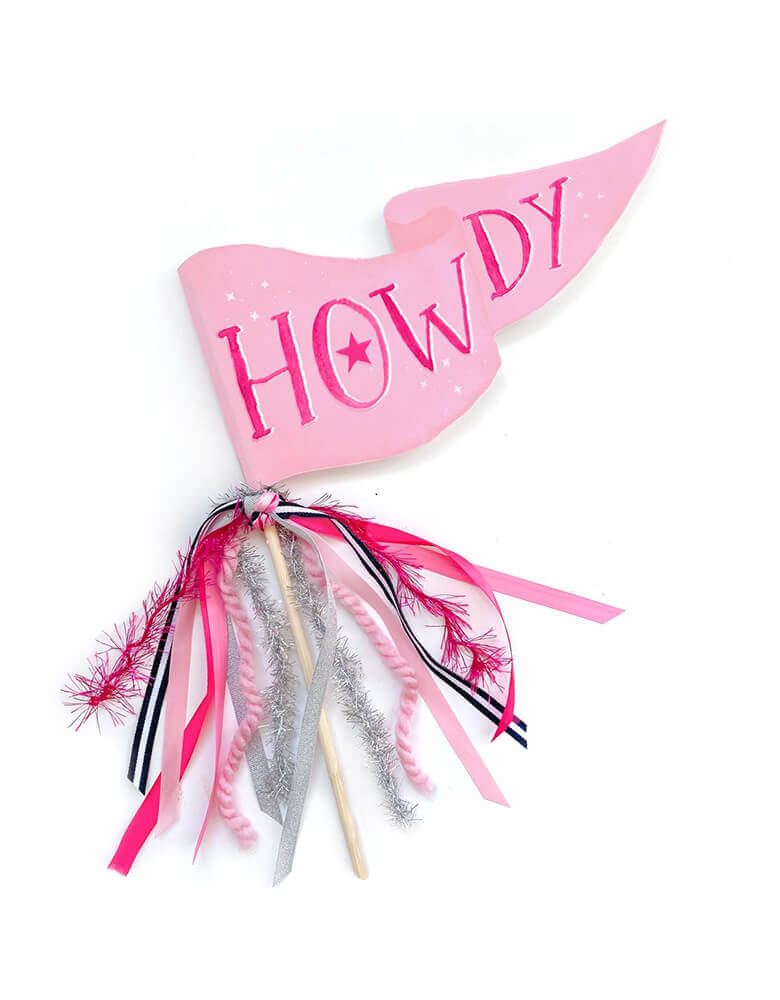 Momo Party's pink Howdy cowgirl party pennant by Cami Monet. Pennant flags are approximately 10" x 5" on a 12" wooden dowel and come fully assembled. This fun party pennant with pink and silver ribbons is perfect for bachelorette parties, cowboy or derby parties, country concerts, horse-themed celebrations and more!