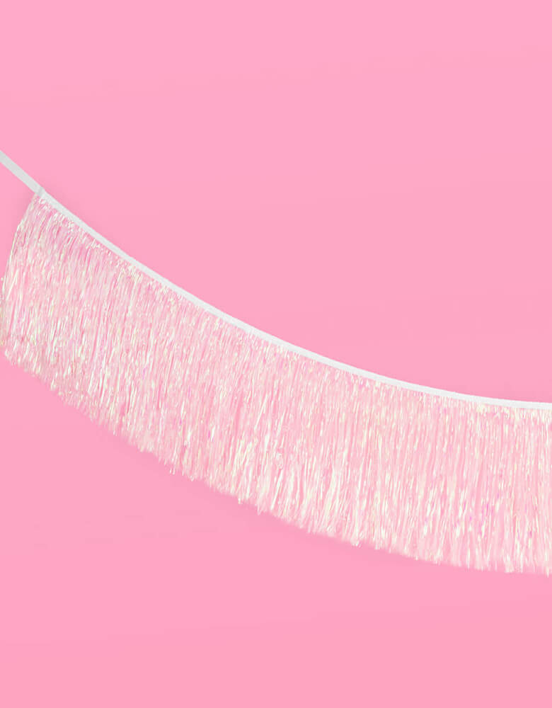 Momo Party's 5' Iridescent Tinsel Fringe Garland by Xo, fetti. This pre-strung foil fringe banner is perfect to set a scene for your party photo backdrop. Perfect for kid's mermaid, unicorn themed birthday party or a preteen, teenager's dance party!