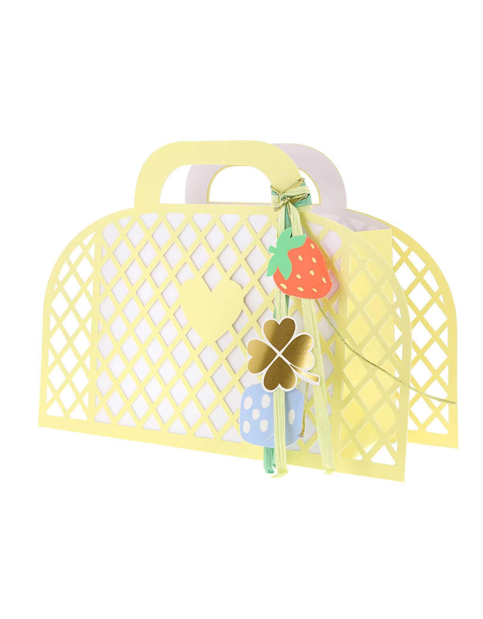 Momo Party's pastel yellow paper tote basket with decorative keychain charm elements by Meri Meri on a white background.