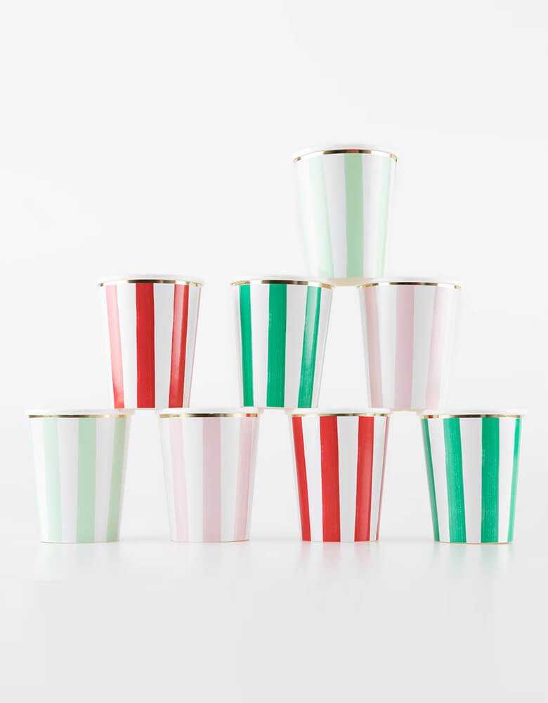 Momo Party's 9oz festive striped party cups by Meri Meri stacked. Comes in a set of 8 cups in 4 different colors including red, pink, mint and green with gold foil edge, they're modern and chic for your Holidays gatherings. Make your Christmas drinks look so special when served in these colorful cups. They're the perfect size for all ages.