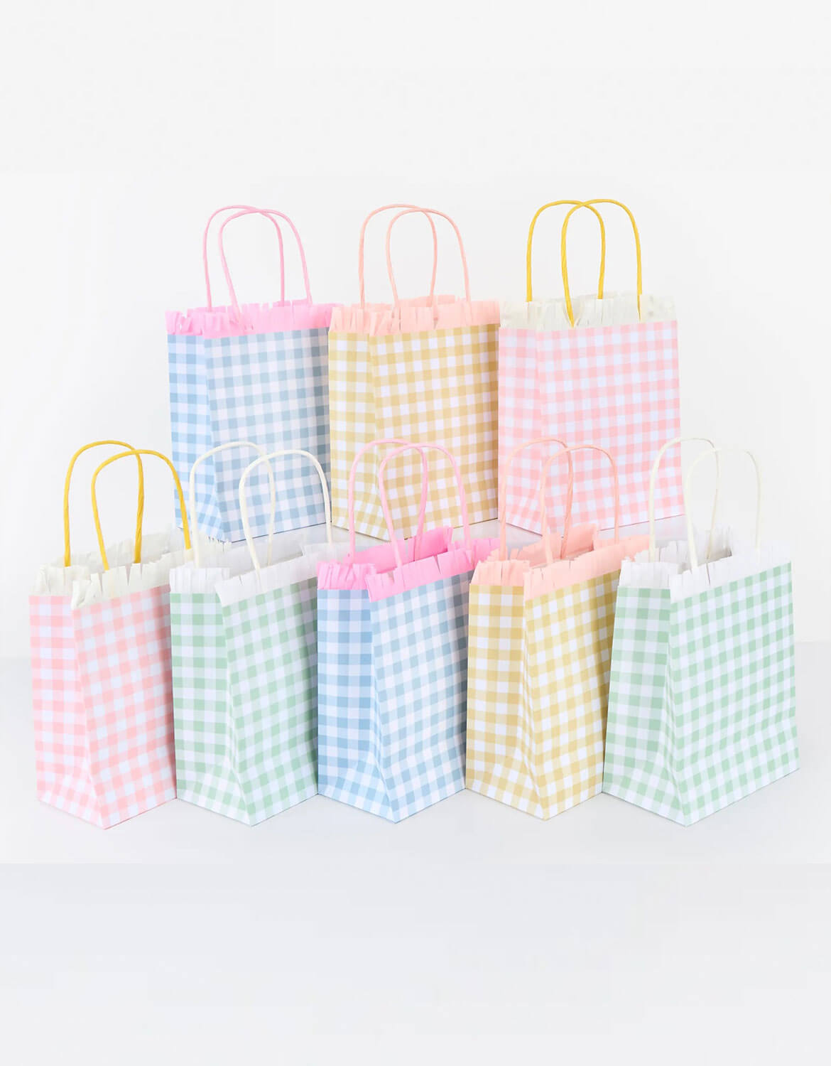 A set of Momo Party's party bags with pastel gingham patterns in four color by Meri Meri on a white background.