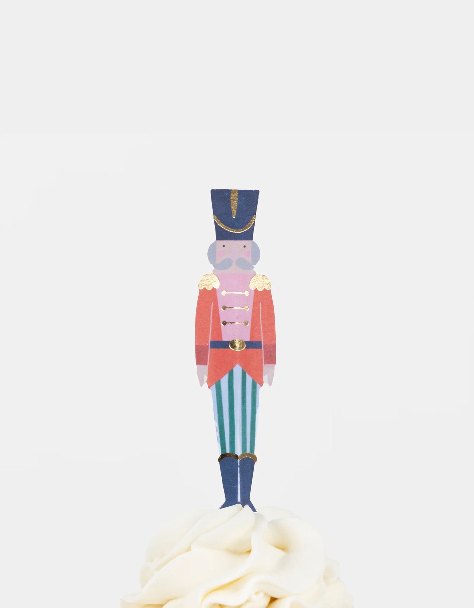 A cupcake decorated with Momo Party's Nutcracker soldier topper.
