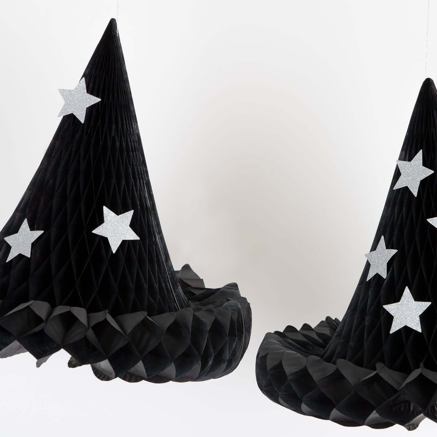 Meri Meri Hanging Honeycomb Witch Hat Decorations, Sale by Momo Party. This 13.25" x 12.875" Witch Hat Hanging Decorations made by tissue paper honeycomb witch hats, with silver paper clips to hold them open. Whether they are hanging in your home, or gently swaying in your porch or garden, these versatile witch hats will delight all visitors on Halloween.  The glitter stars will shine brightly to mesmerize your guests too.