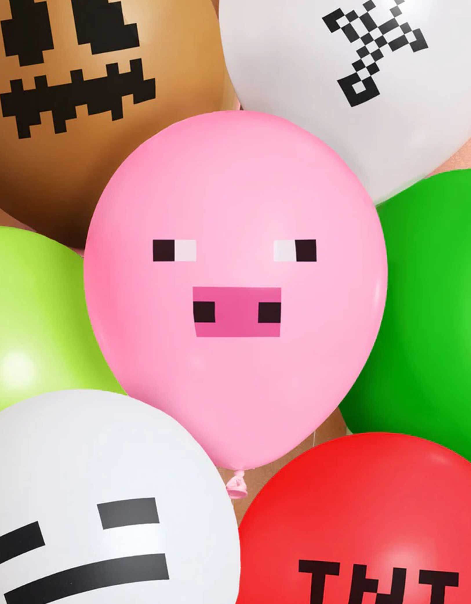 A closeup shot of 11" Minecraft Pixel balloon bunch from Momo Party featuring various colors of latex balloons with pixelated faces and 'TNT' text.
