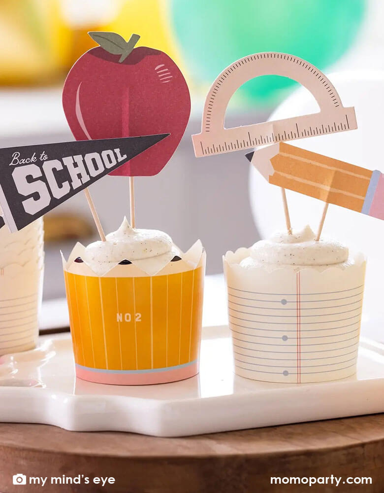 Momo Party's back to school food cups with toppers by My Mind's Eye. Featuring a notebook paper and pencil design these baking cups will give your goodies top marks. And for extra credit, the baking cups come with 4 unique picks including: a pencils, a protractor, an apple, and a back to school pennant. They're perfect for you kid's back to school party or first day of school breakfast celebration!