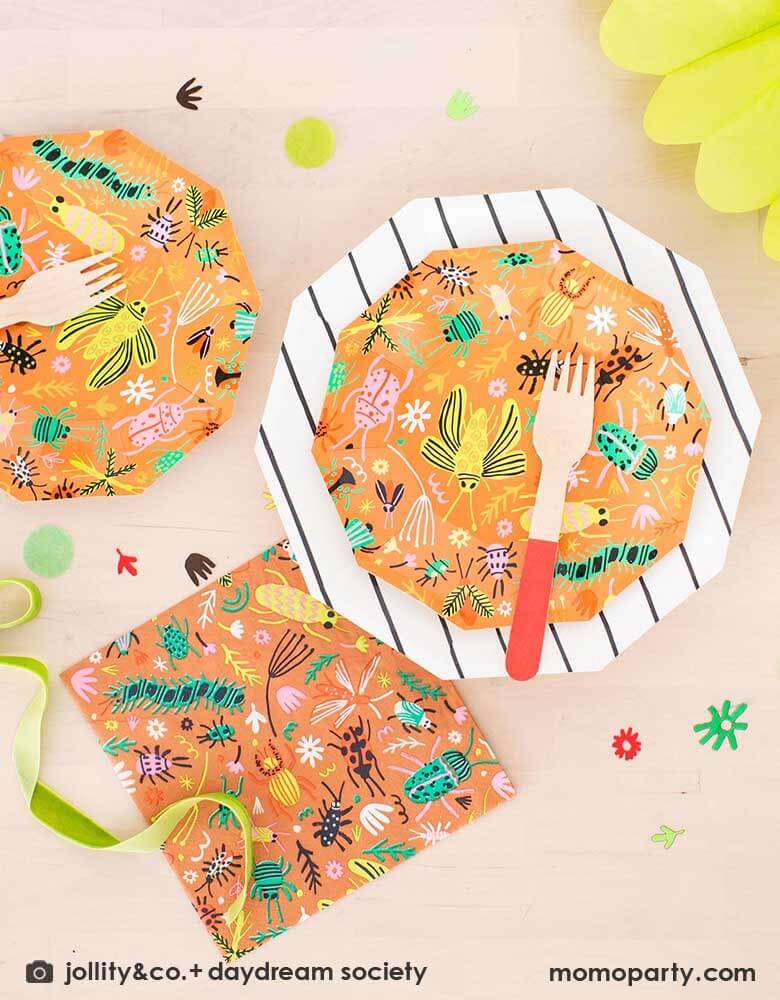 A kid's bug theme birthday party table filled with Momo Party's backyard bug themed party supplies and tableware including plates, napkins and confetti. With neon tone bugs in modern illustrations, these bug themed partyware if perfect for your child's crawling bug inspired party!