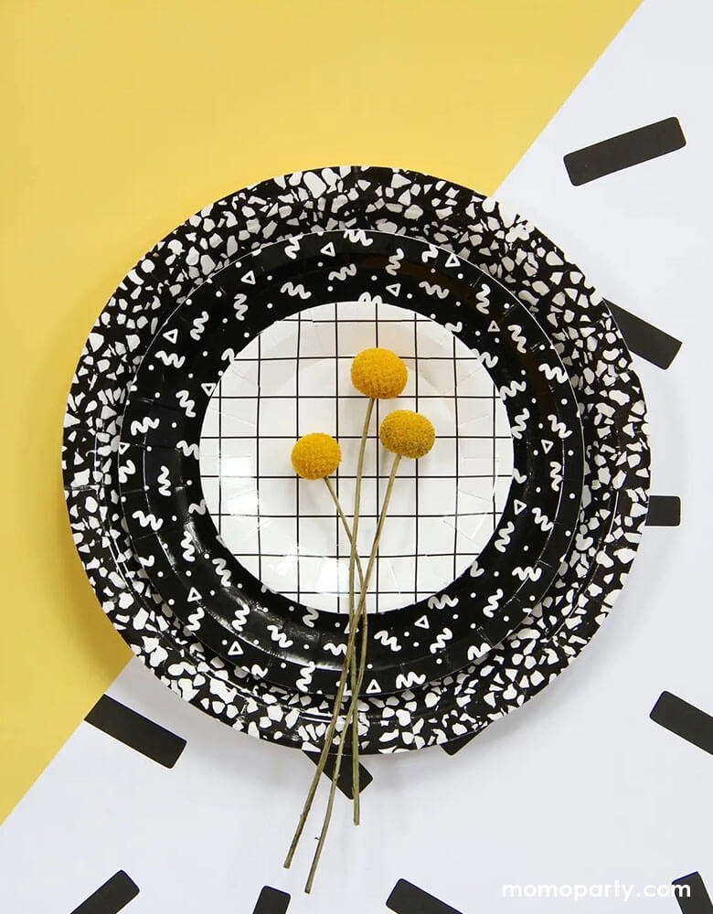 Momo Party's black and white patterned plates by BASH Party Goods - Art School Speckle Large Plates in black layered with Art School Squiggle Small Plates layered and Grid 4.25" Mini Canape Plate and Craspedia Billy Balls. Mix and match grids, squiggles, and speckles for the perfect bold accent for a modern party.