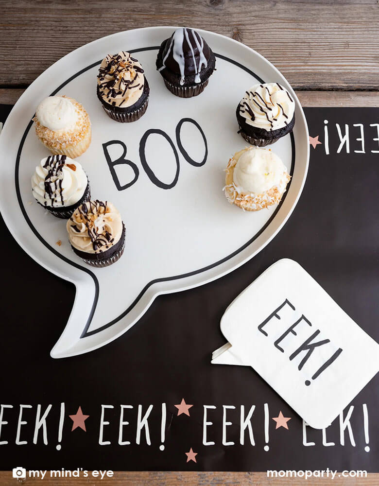 A fun Halloween table featuring Momo Party's Boo Reusable bamboo tray and Eek! napkins on the Frank & Mummy Eek! Table Runner by My Mind's Eye. Featuring the spooky phrase "Eek!' and copper foil stars this table runner is the perfect addition to the table at your Halloween gatherings.