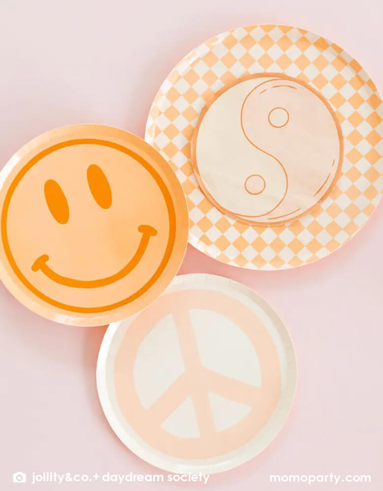 Momo Party's Love and Peach collection by Jollity & Co. featuring 8" smily face dessert plate in peach, 10" Check it! Peach and cream checker patterned dinner plates, pairing with love and peace yin yan symbol napkins and light peach peace and love sign dessert plate.