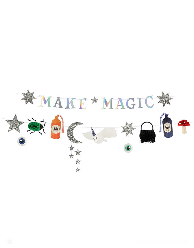 Momo Party's 5.75' Making Magic Party Garland by Meri Meri. It's perfect to hang on walls, in doorways or on the party table. It's also a terrific Halloween party garland.  The first garland features the words "Make Magic" with silver holographic foil, and stars covered with chunky silver glitter fabric The second garland features a cauldron, mushroom, beetle and eyeballs with honeycomb details; chunky silver glitter fabric moon and stars; potion bottles with blue and orange yarn; and a 3D flying owl.