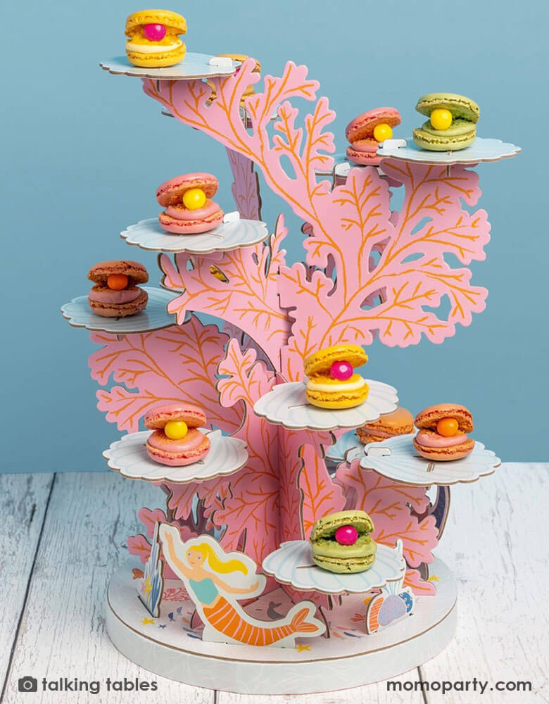 Momo Party's 1.4″ x 10.5″ x 15″ Mermaid Coral Cupcake Stand by Talking Tables. With colorful macaroon on this beautiful cupcake holder, this show stopping coral reef mermaid cake stand will be the talk of the party. Featuring mermaids swimming around a colorful coral reef, use the 12 platforms to hold cupcakes, donuts or other sweet treats. It's perfect for kid's under the sea / mermaid birthday parties.