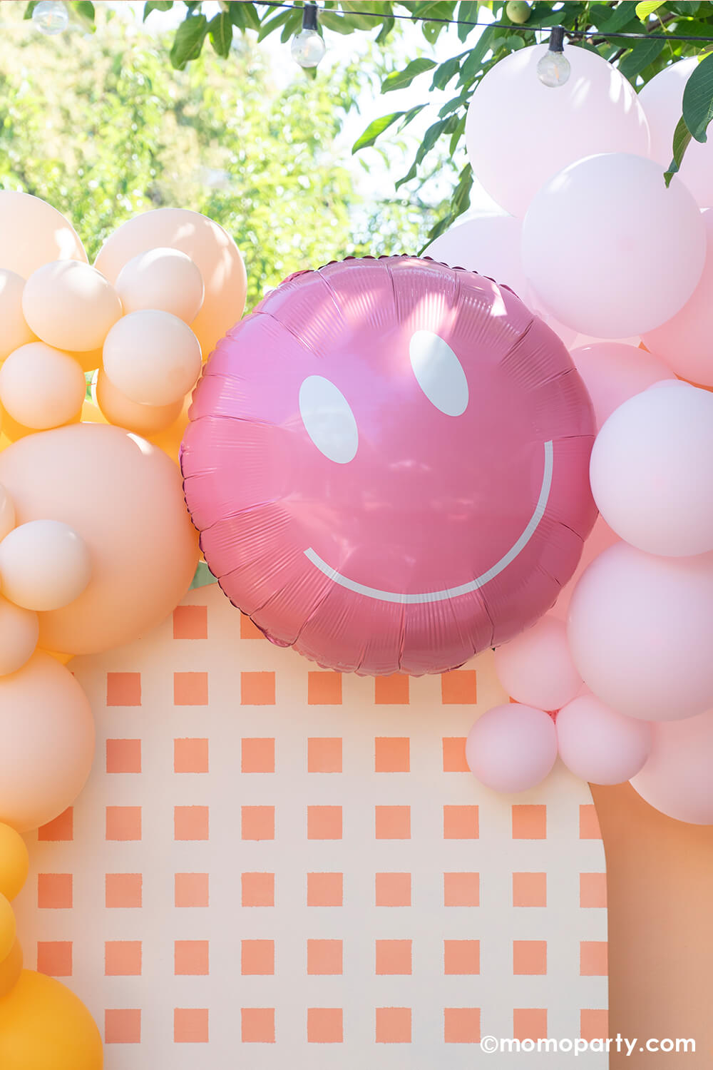 Momo Party One Groovy Baby First Birthday Party Backdrop board with 30" Rosy Smiley face foil balloon by Tuftex Balloons, latex balloon decorations with peach, pink, goldnod colors. This decoration is such a stand out backdrop and photo booth for a Groovy birthday parties, baby showers, and most any other joyful event