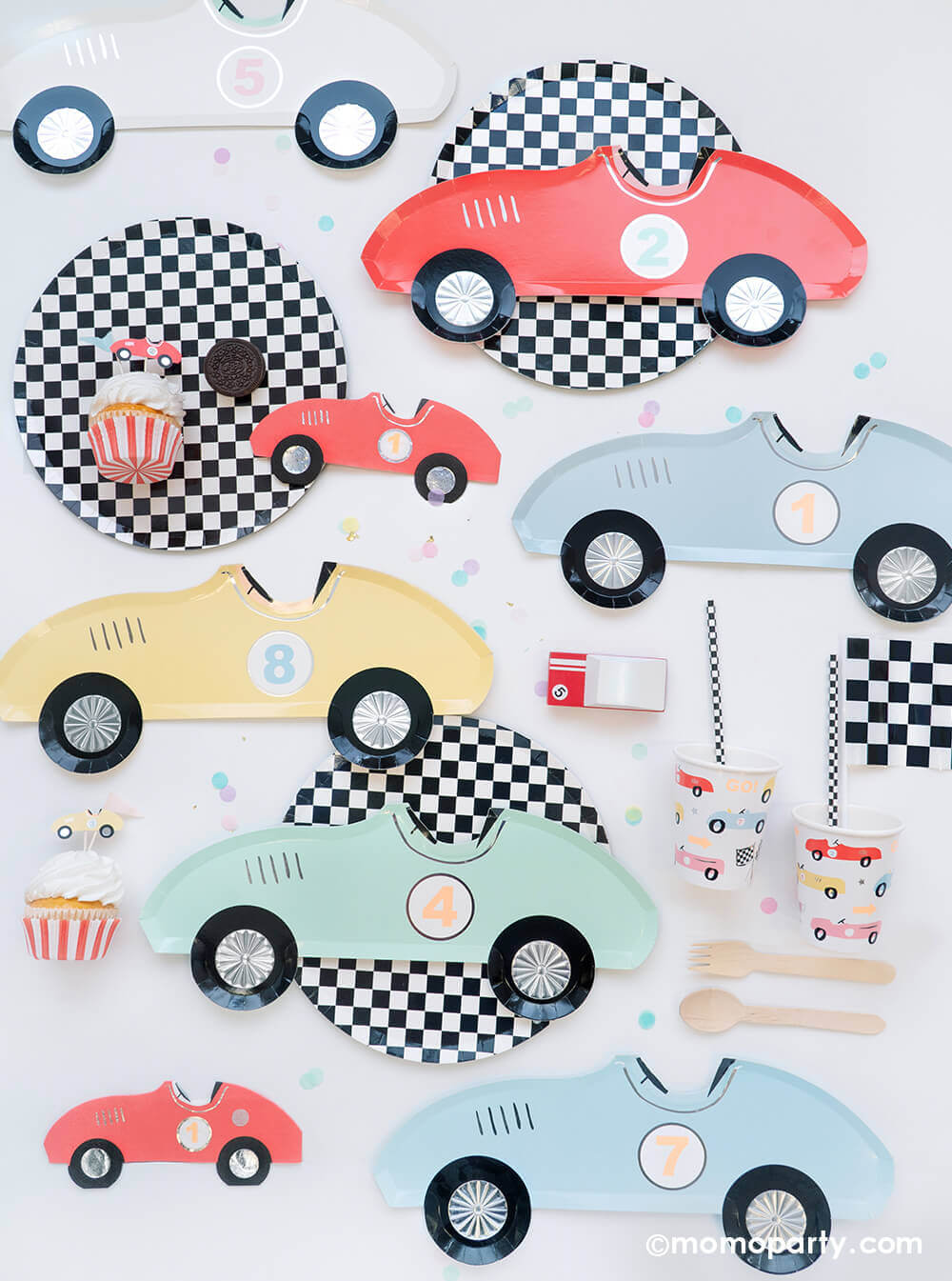 Momo Party's Race Car Party Collection featuring Meri Meri's vintage race car papery plates in 8 different colors, red race car shaped napkins, round checkered dinner plates, race car motif party cups, checkered flags decorations, race car cupcake kit and toppers and Candylab wooden toy race car - perfect for kid's "Two Fast" race car themed second birthday party or "Fast One" first birthday party.