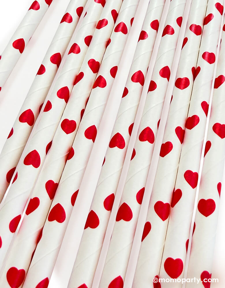 close up of Momo Party's eco friendly disposable paper party straws with red hearts pattern on a white background.