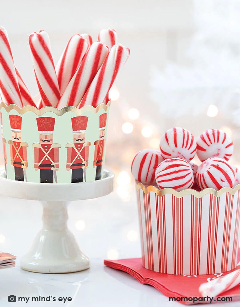 Momo Party's Nutcracker Gold Foiled Soldiers Food Cups by My Mind'e Eye. Featuring Nutcracker soldier design on mint and candy cane red stripes, these food cups are perfect for a Holiday baking party.