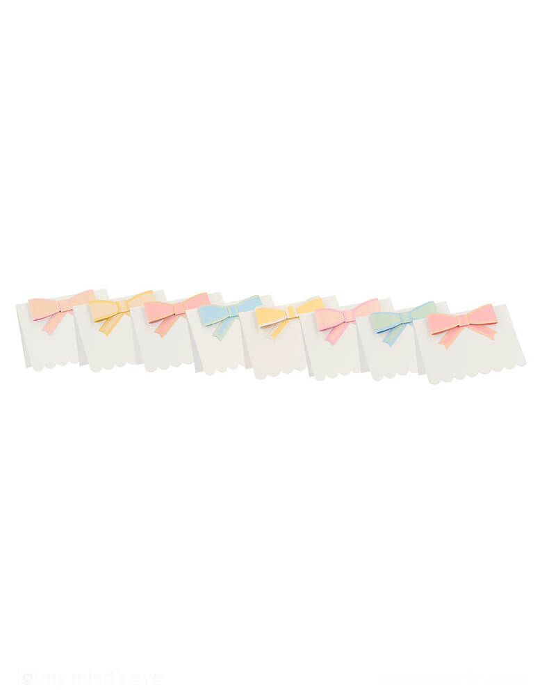 Momo Party's 3.5"x 2.5" Pastel Bow Place Cards by Meri Meri. Featuring pretty pastel colors in 8 different colors, including pale pink, pink, dark pink, ivory, yellow, peach, mint and blue, each of the place card has a 3D paper bow on them, making this an elegant yet darling addition to your tableset.